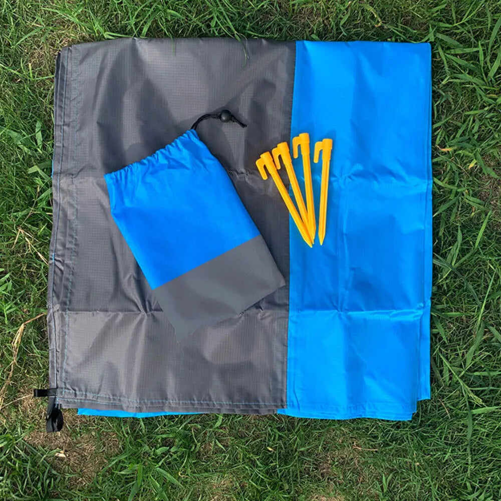 Belro heavy-duty camping tent beach picnic blanket tarp spread on outdoor ground with trees in background