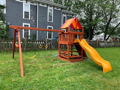 Casavibeo Woodplay Tiger Tower A wooden playset featuring a tiger-themed cedar structure for outdoor play and climbing fun.