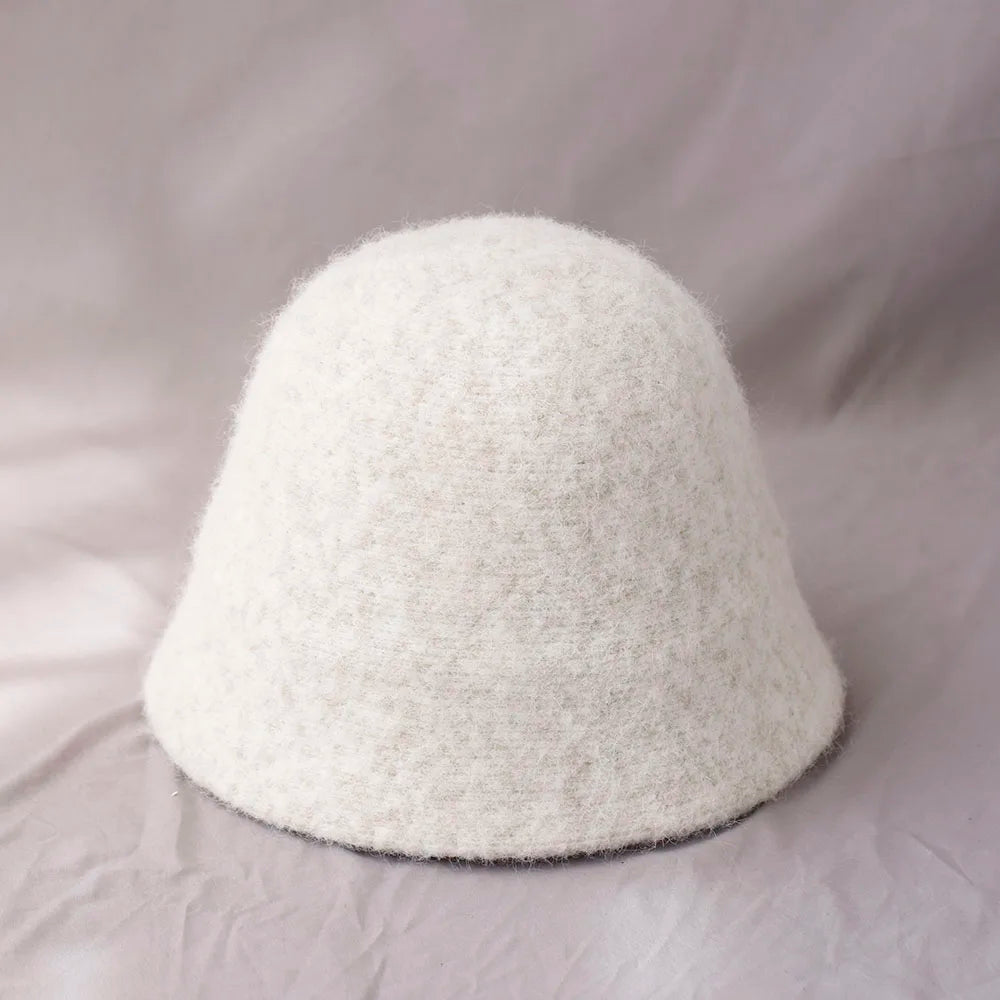 White women's winter wool bucket hat by Belro, featuring a cozy, wide-brim design perfect for cold weather accessories.