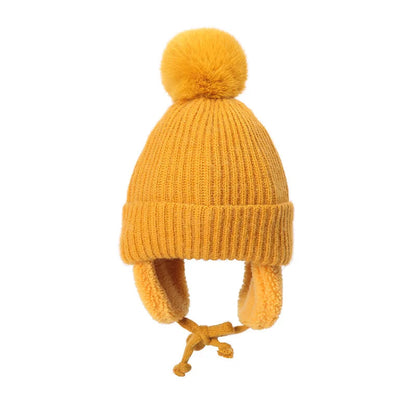 Yellow kids knit beanie winter hat with earflaps from Belro, cozy and warm for cold weather, featuring a soft knit texture.